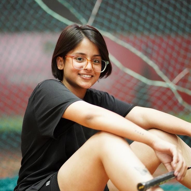 Kaveri Mehta, Lead Design Curator at MapleSeasideRiverbank, reviewing corporate floral arrangements